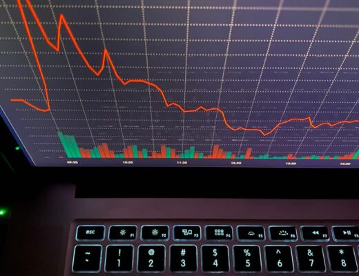 Ilustračný stock: finančný graf na monitore, civilný záber, bez crypto meme, bez falošného broker UI a bez bankoviek ako záruky.